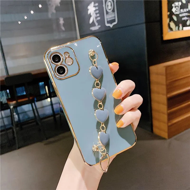 Silicone phone case with wrist bracelet for Samsung smartphones in solid green, pink, purple, or light green.