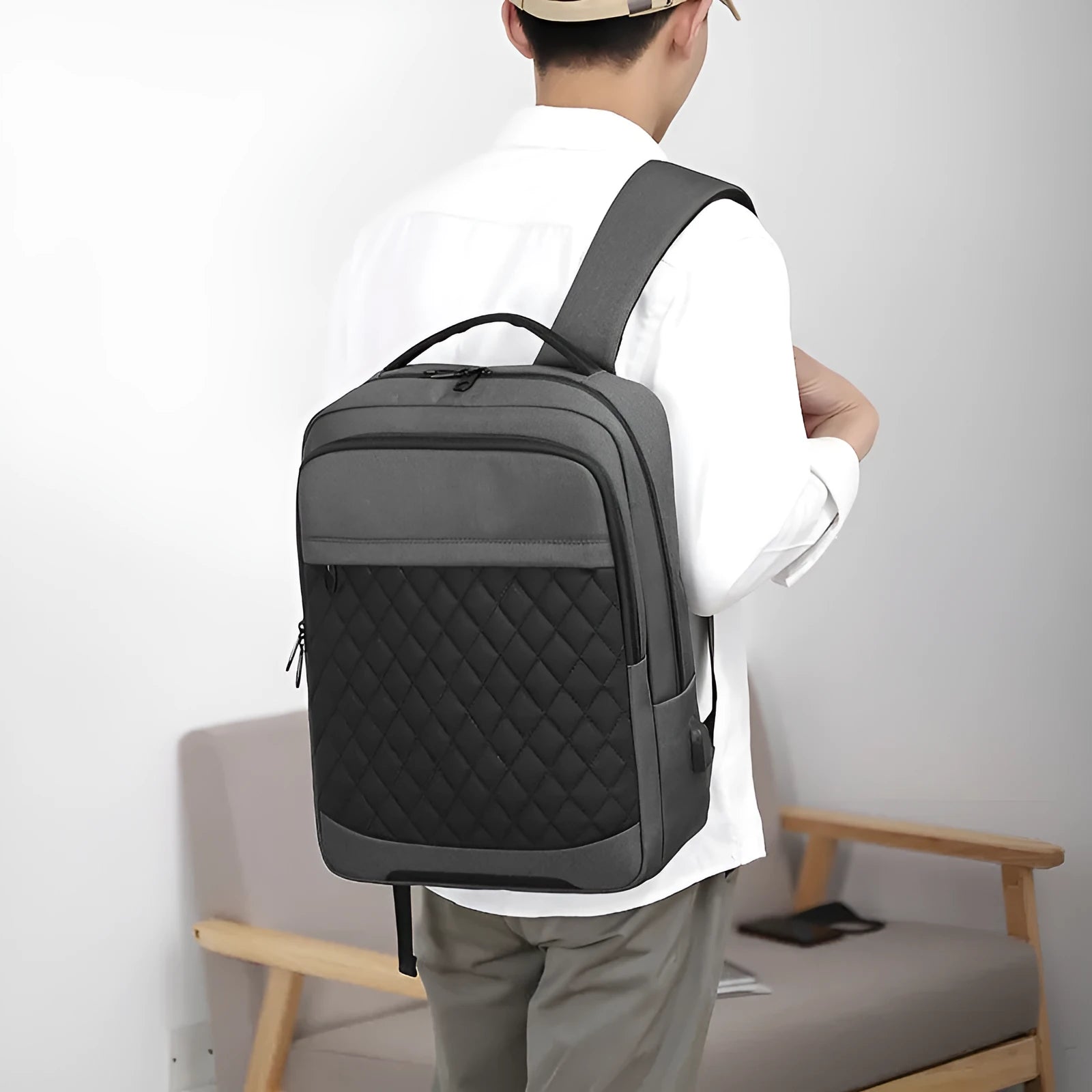 Men's black Oxford cloth travel backpack with curved shoulder straps and diamond mesh back panel