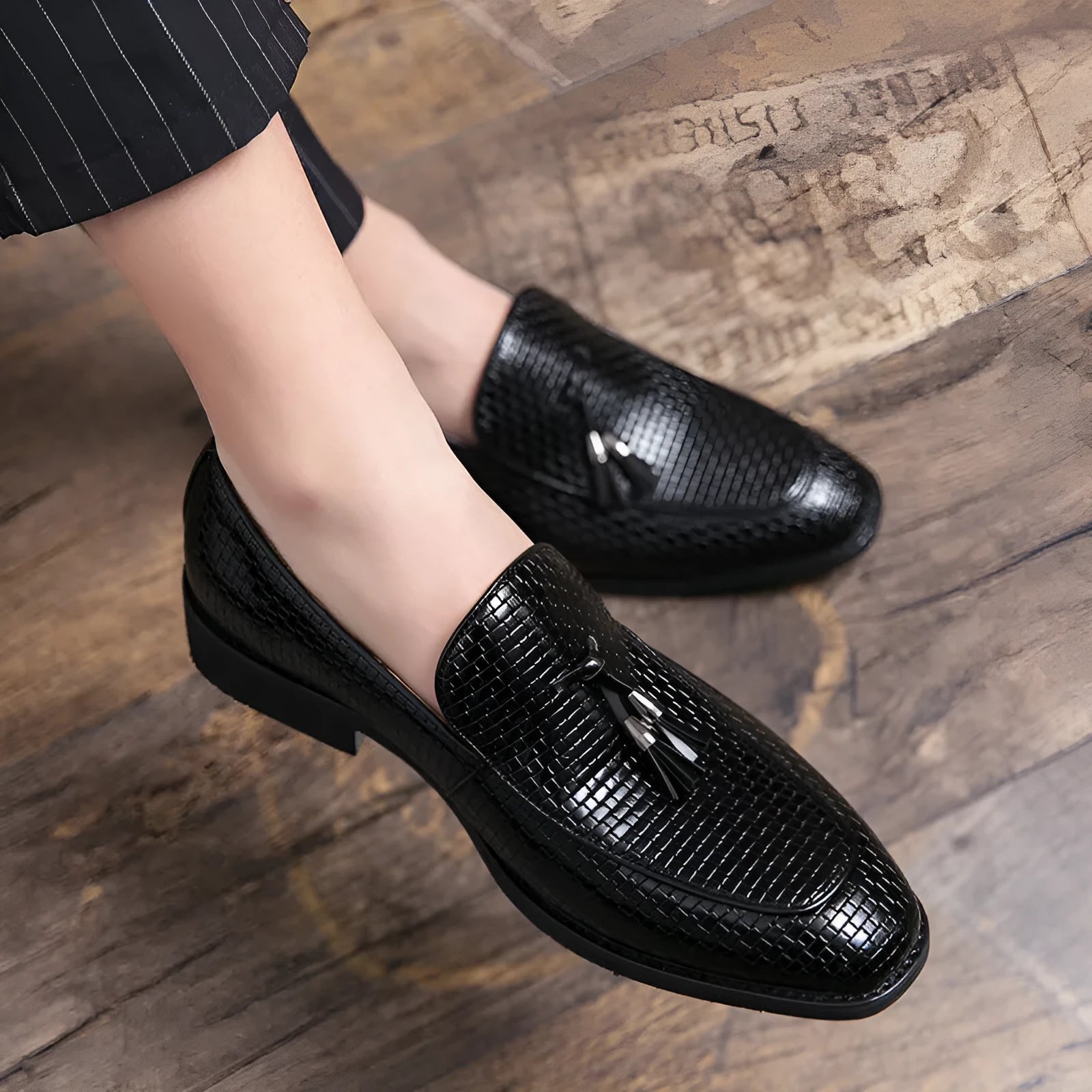 Men's black slip on loafers with pointed toe and tassel detail on PU leather upper