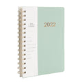 Blue 17-month 2022-2023 student planner with coil binding, month grid, and pockets.