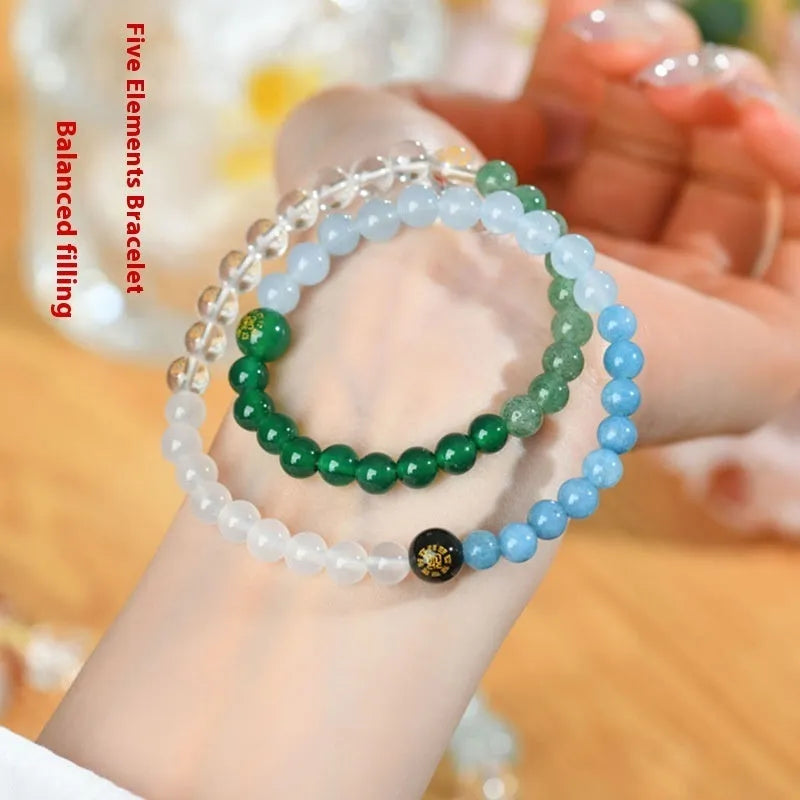 Handmade women's crystal double ring bracelet in five elements colours on a wrist.