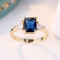 Rectangular gold sapphire blue copper women's ring showing geometric band shape