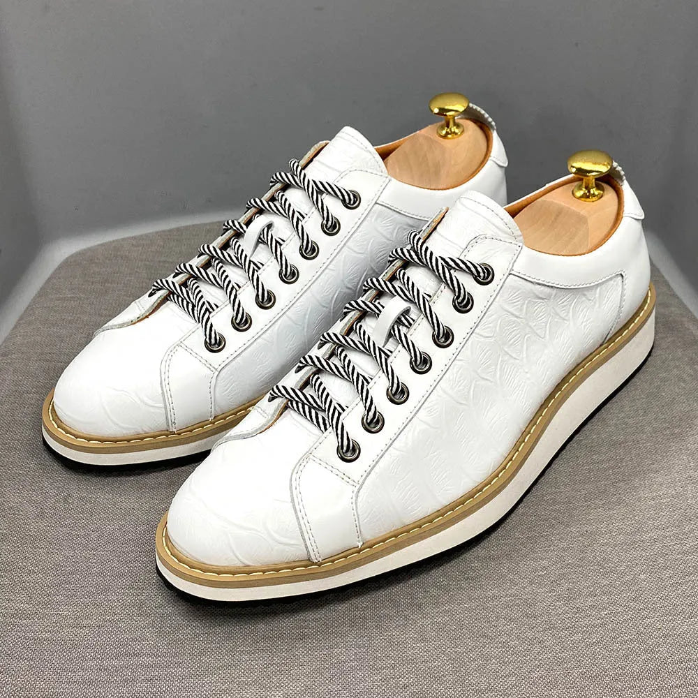 Handmade men's low-cut shoes with an embossed pattern and front-tie lacing.