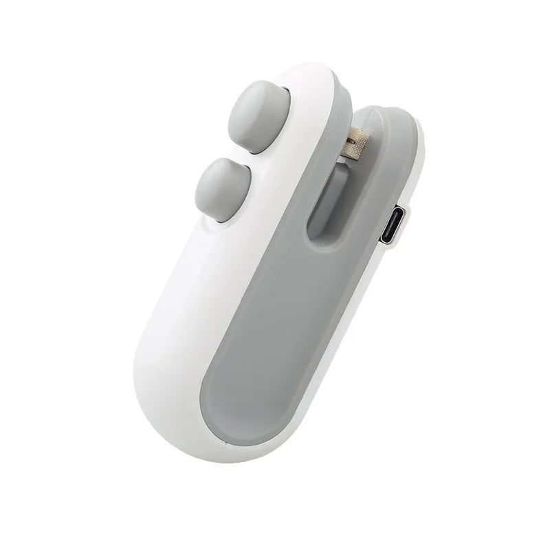 Blue and white handheld USB rechargeable heat sealer with magnetic back on a metal surface.