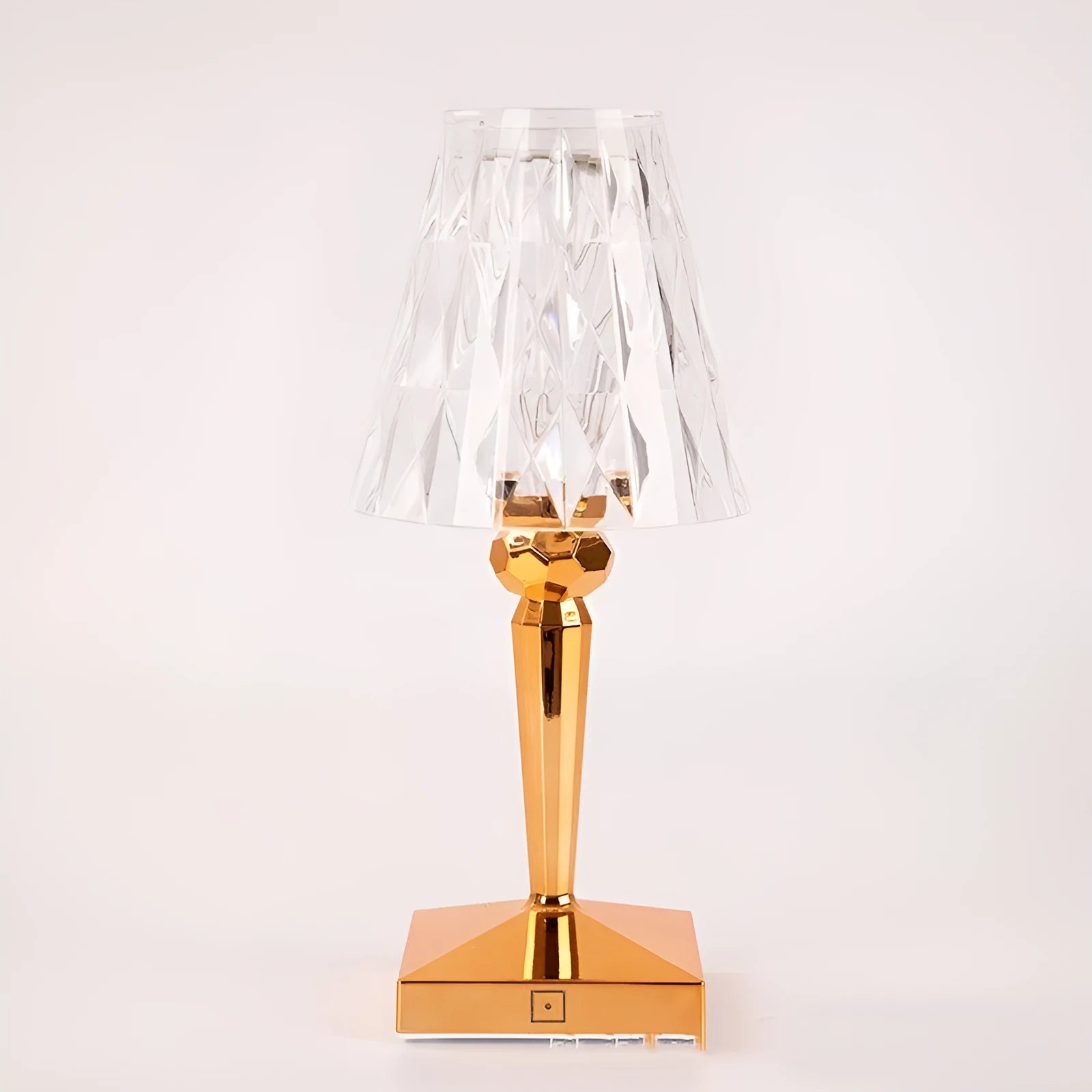 Rose gold plated portable touch night light with rechargeable battery on a table.