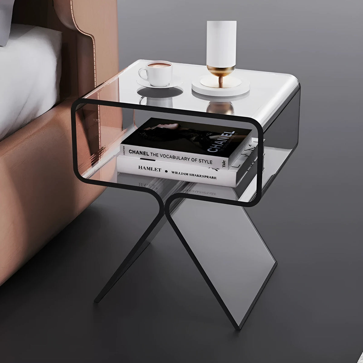 Minimalist acrylic side table in transparent black, 39x30x45cm, beside a sofa in a living room