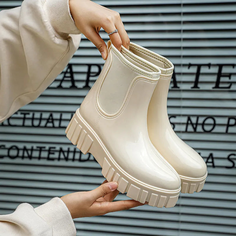 A pair of low tube PVC rain boots with a flat heel, shown in a solid colour on a white background.