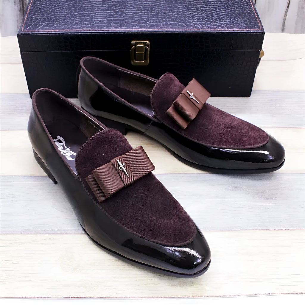 Men's glossy black patent leather low-top shoes with a tassel detail on a white background.