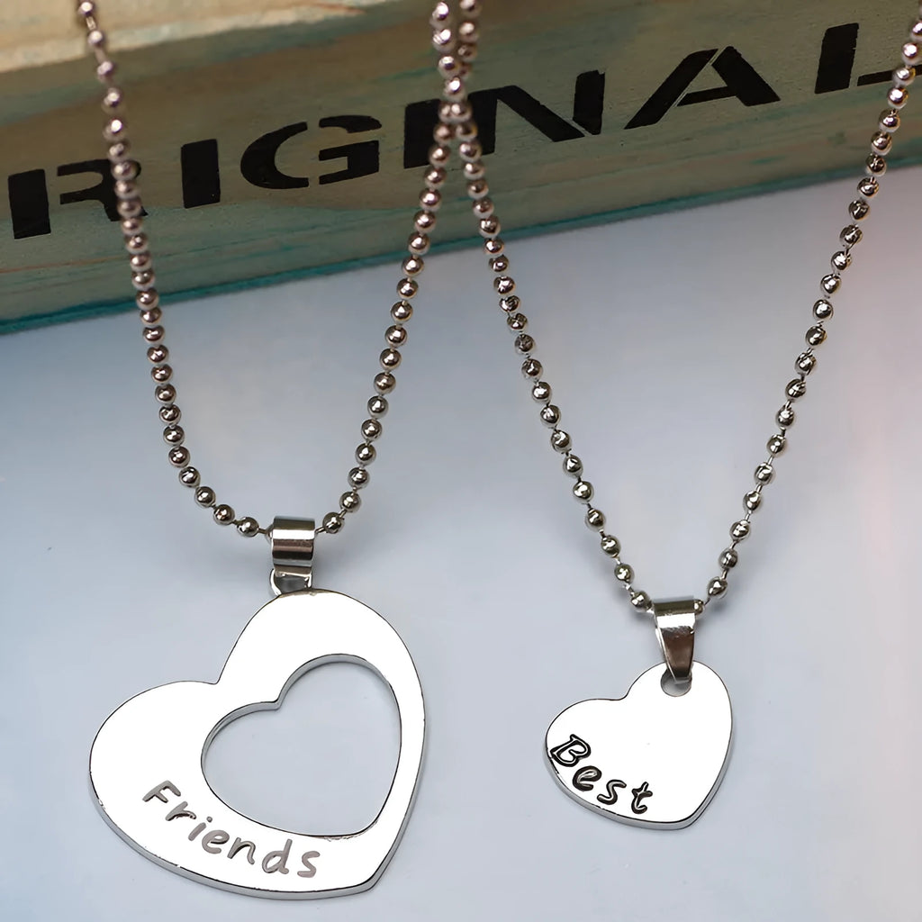 Two silver alloy heart-shaped puzzle necklaces on cross chains, matching set