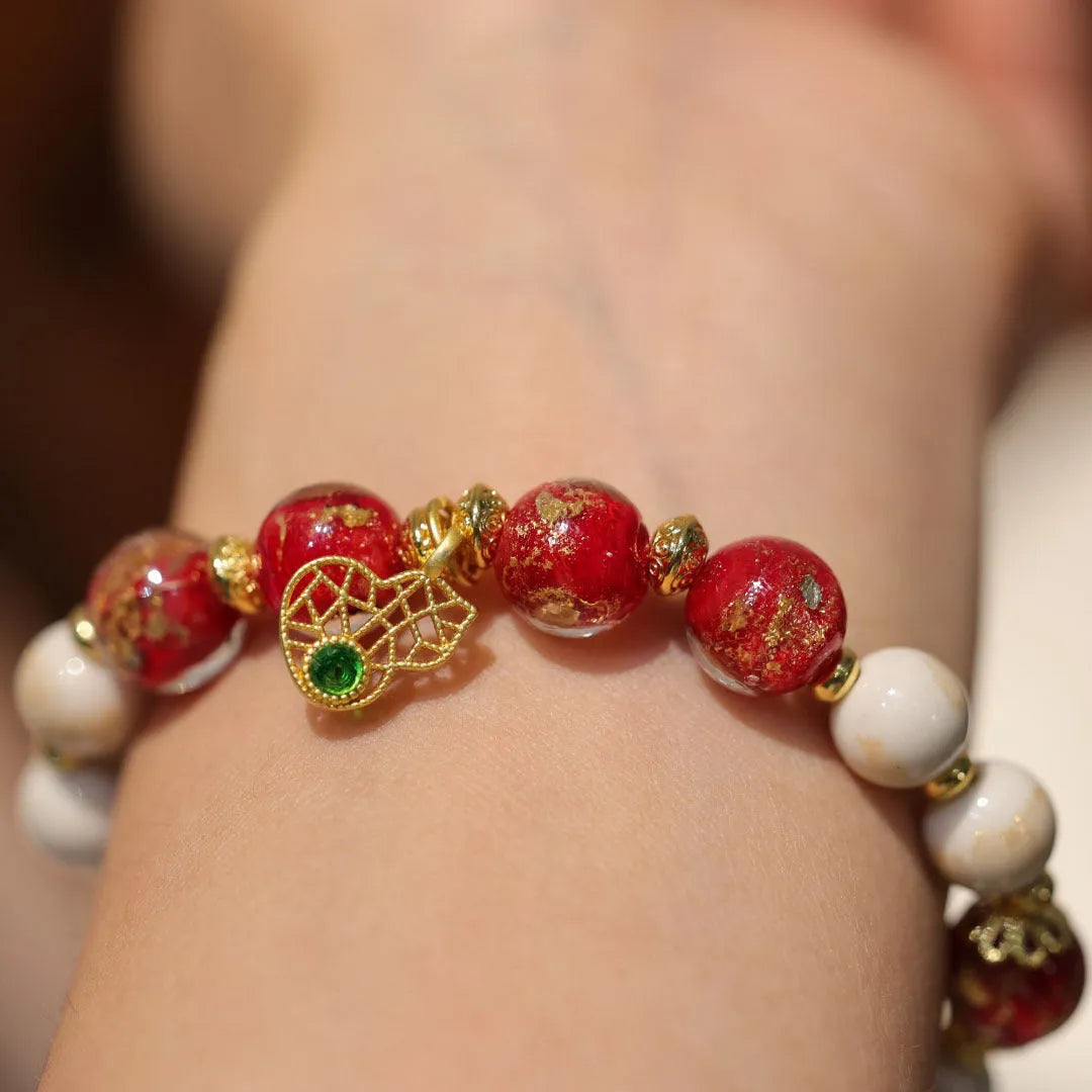 Women's handmade coloured glaze bracelet with gold foil decoration in geometric ethnic style design