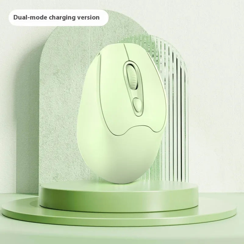 Bluetooth wireless mouse in choice of girl pink, milk tea pink, grey or green colours on a desk next to a laptop.