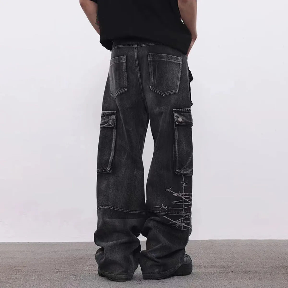 Black men's cotton wide-leg loose-fit trousers with embroidery on a mannequin.