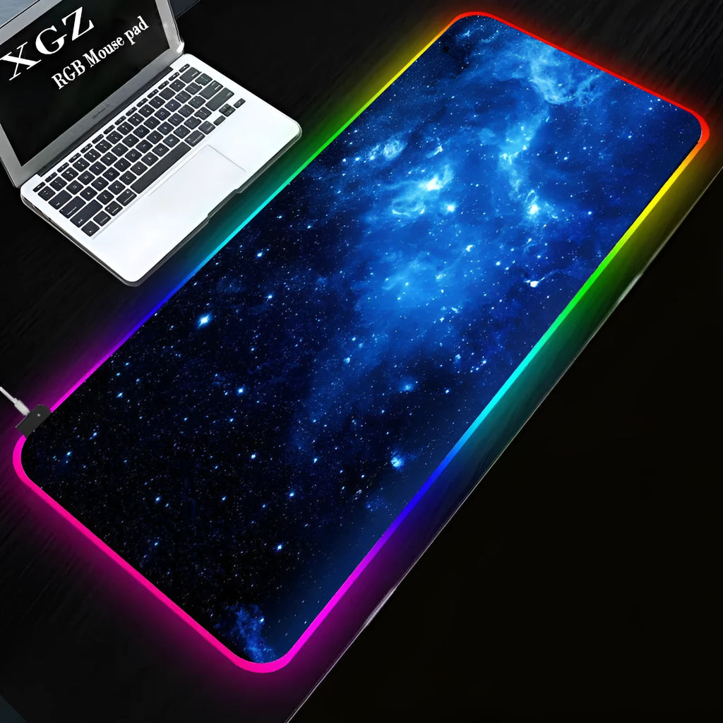 Starry sky pattern RGB luminous gaming mouse pad with USB cable on a desk