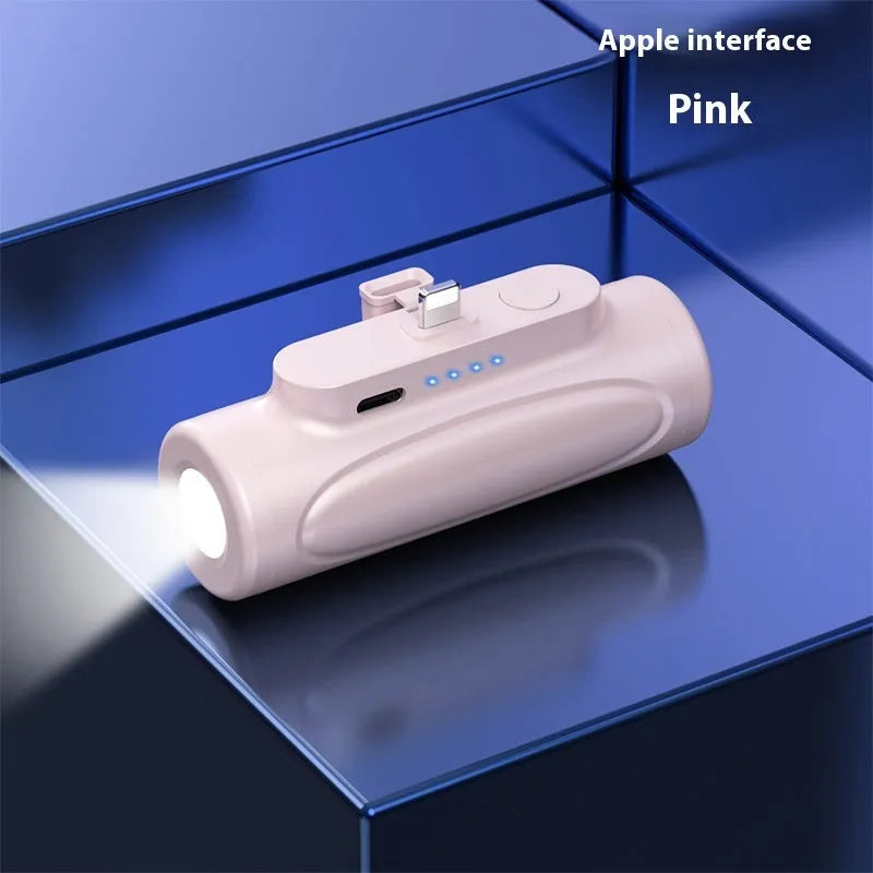 Black and pink portable power bank with integrated LED flashlight, showing USB-C and Apple port options.