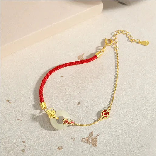 925 sterling silver red rope bracelet with a gold koi peace buckle safety clasp.
