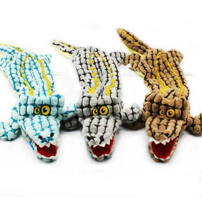 Blue crocodile-shaped plush squeaky dog toy with corduroy fabric on a wooden floor.
