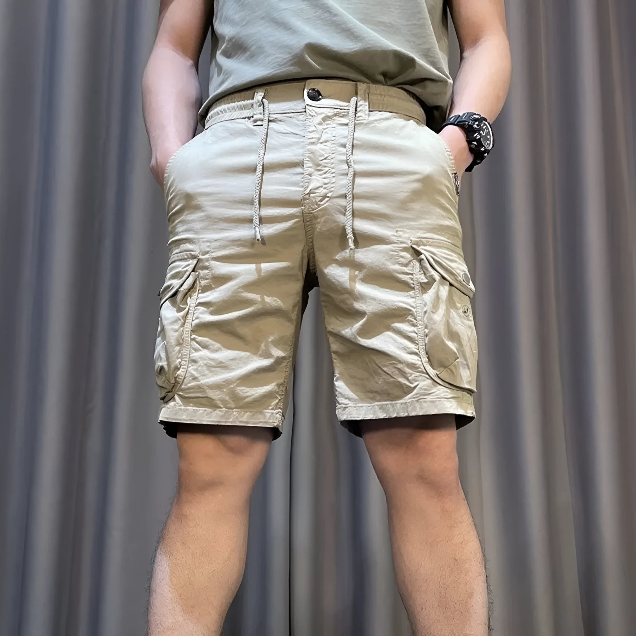 Loose straight-leg multi-pocket casual overalls trousers in khaki colour on a hanger.