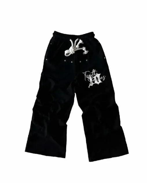 Black fleece embroidered printed loose fit pullover sweatpants on a model