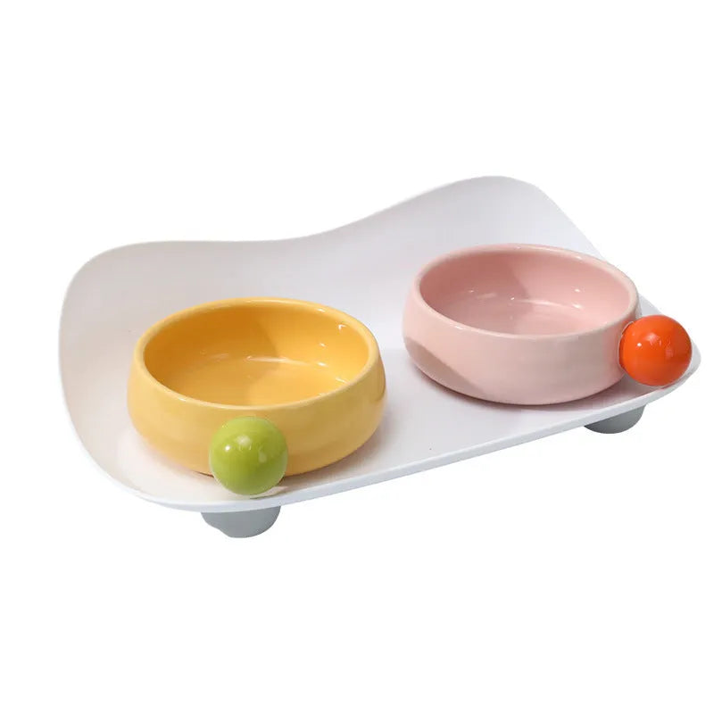 Elevated ceramic pet feeding bowl with two compartments and a non-slip base in a choice of colours.