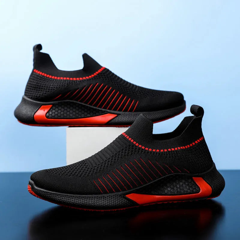 Men's black and white striped slip-on sneakers with lace-up front and mesh design.