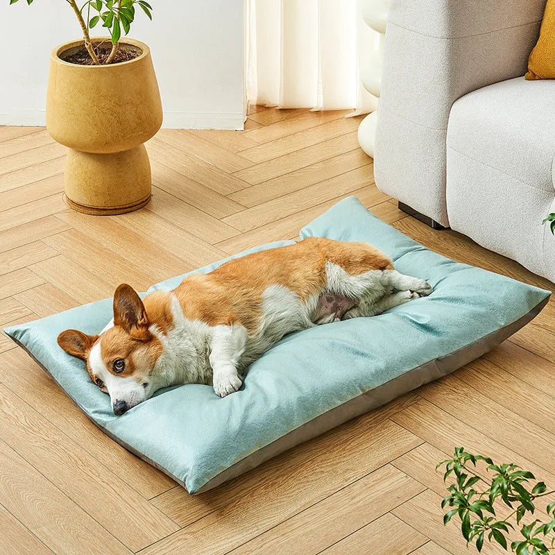 Blue plush fabric pet sleeping mat for cats or small dogs shown in a home setting.