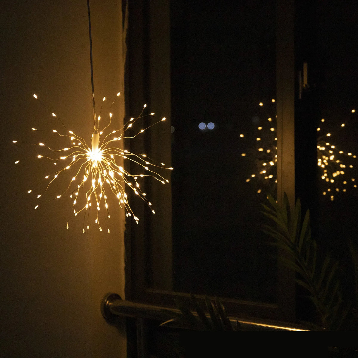 Outdoor waterproof dandelion string lights with warm colour glow on a garden fence