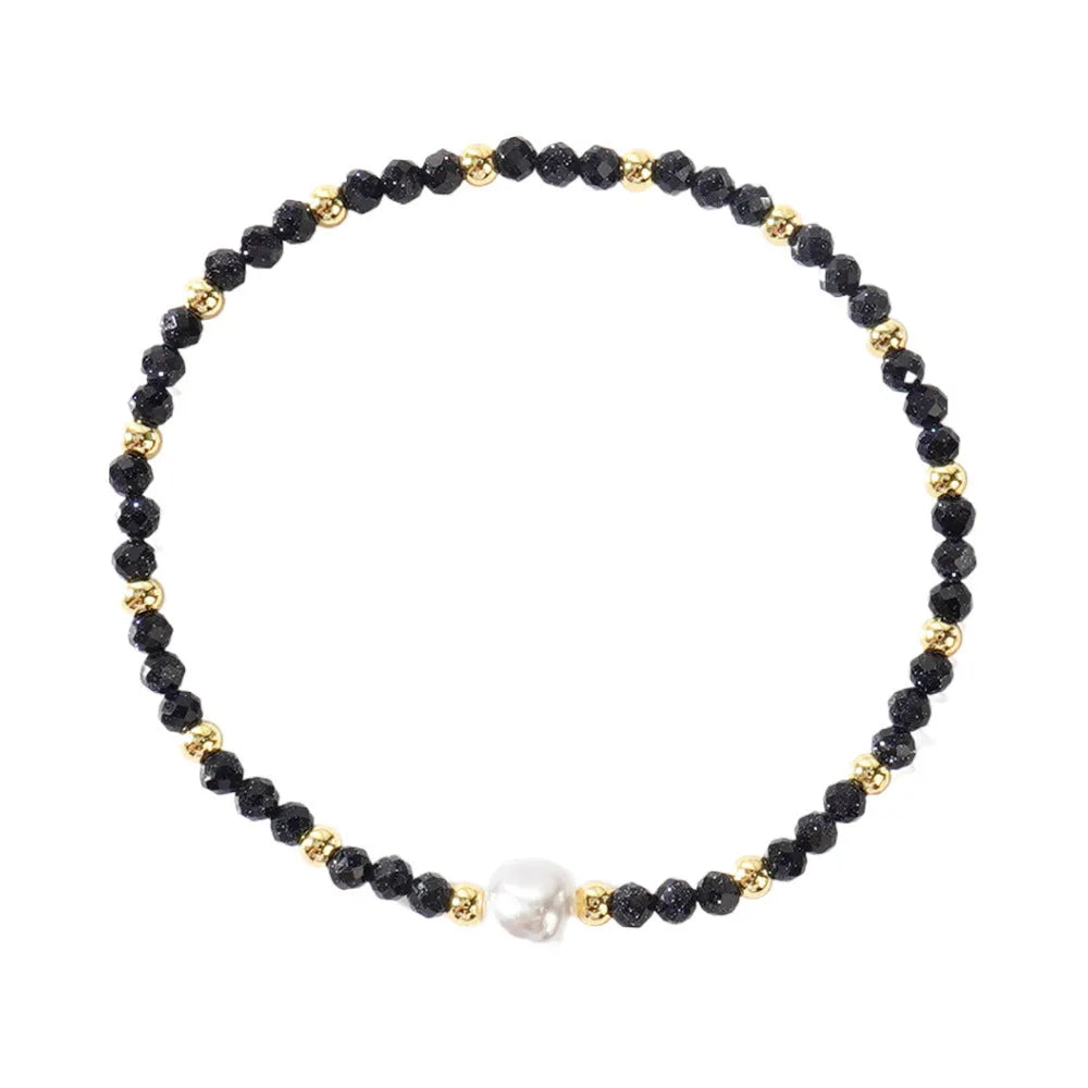 Close-up of a unisex natural stone bracelet with geometric ellipse beads on a wrist.