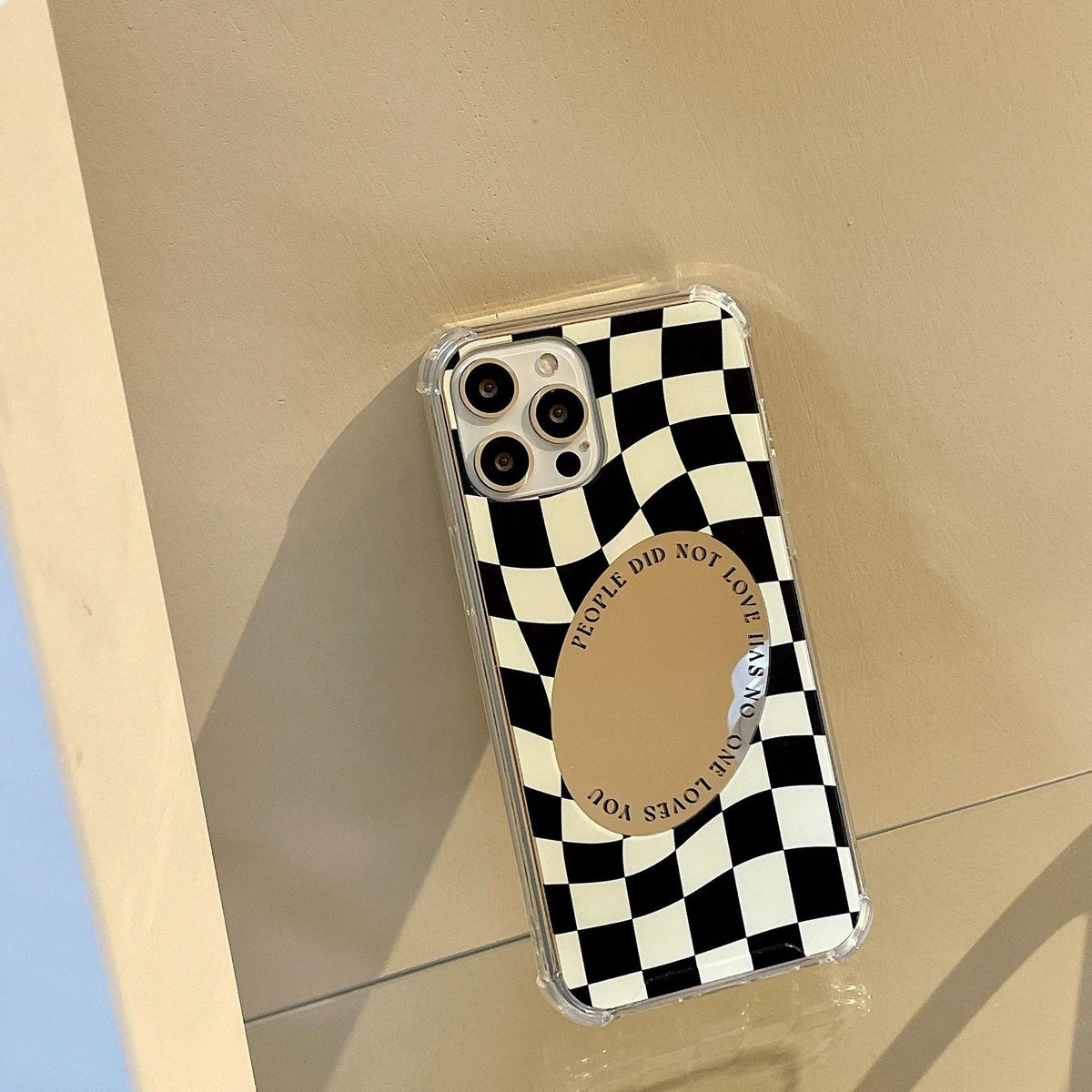 Mirror phone case with chessboard plaid pattern against black background