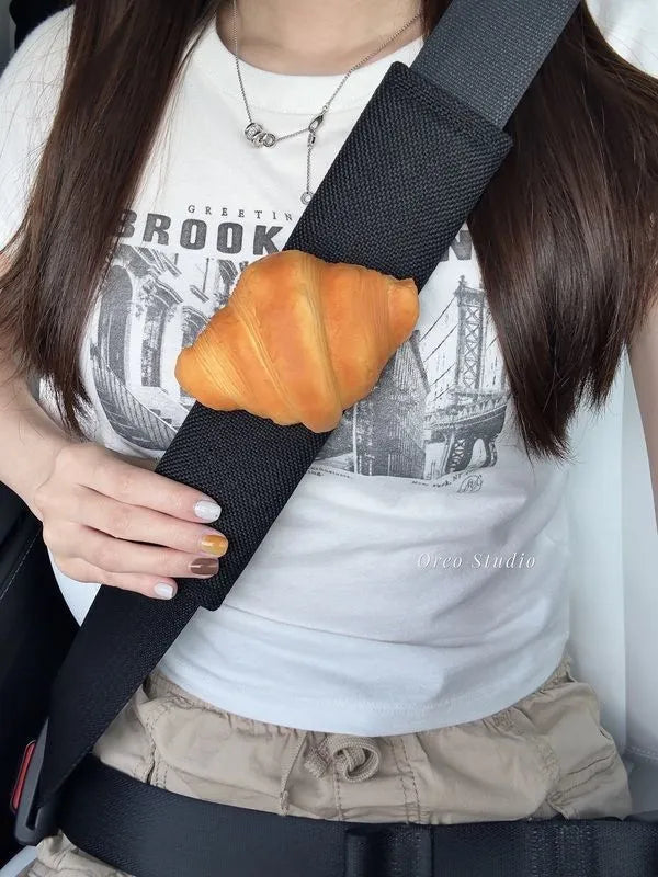 Toast bread safety belt shoulder pad in white toast colour on a car seat belt for driving comfort