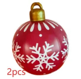 Large red and white striped inflatable Christmas ball ornament hanging on an outdoor tree