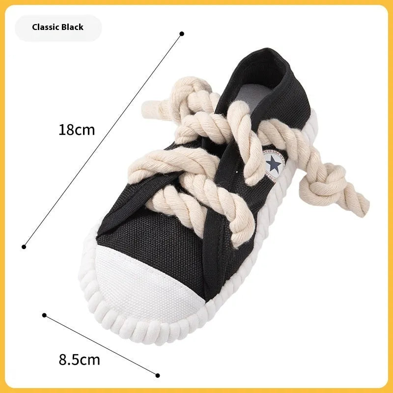 Plastic dog toy shaped like slippers in yellow, black, or blue, designed for chewing and making sound.