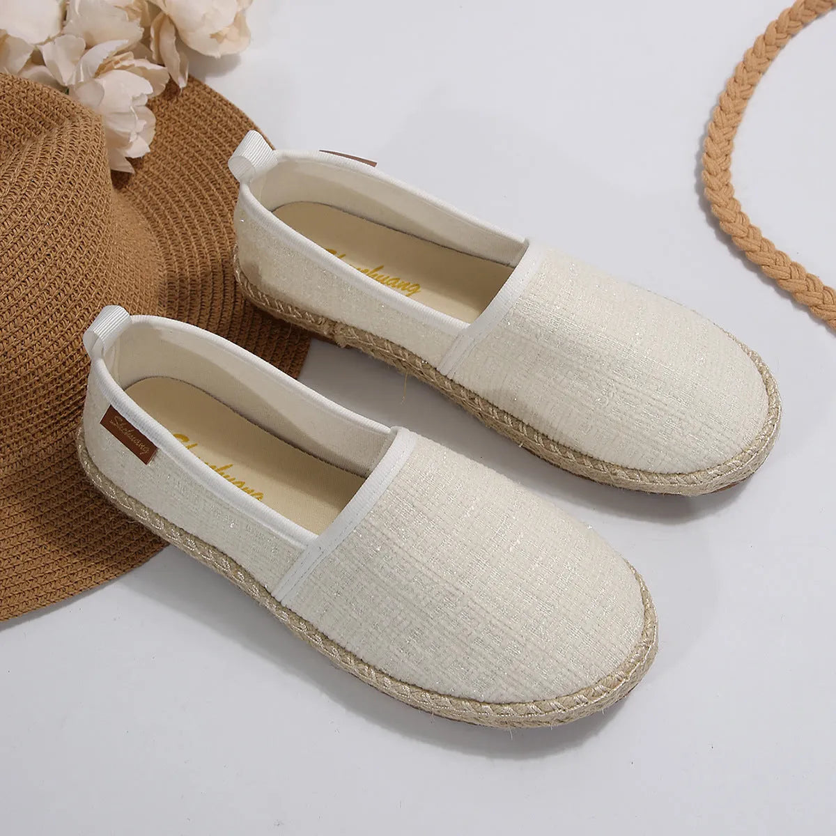 Beige rope sole fisherman shoes with canvas uppers and flat heels