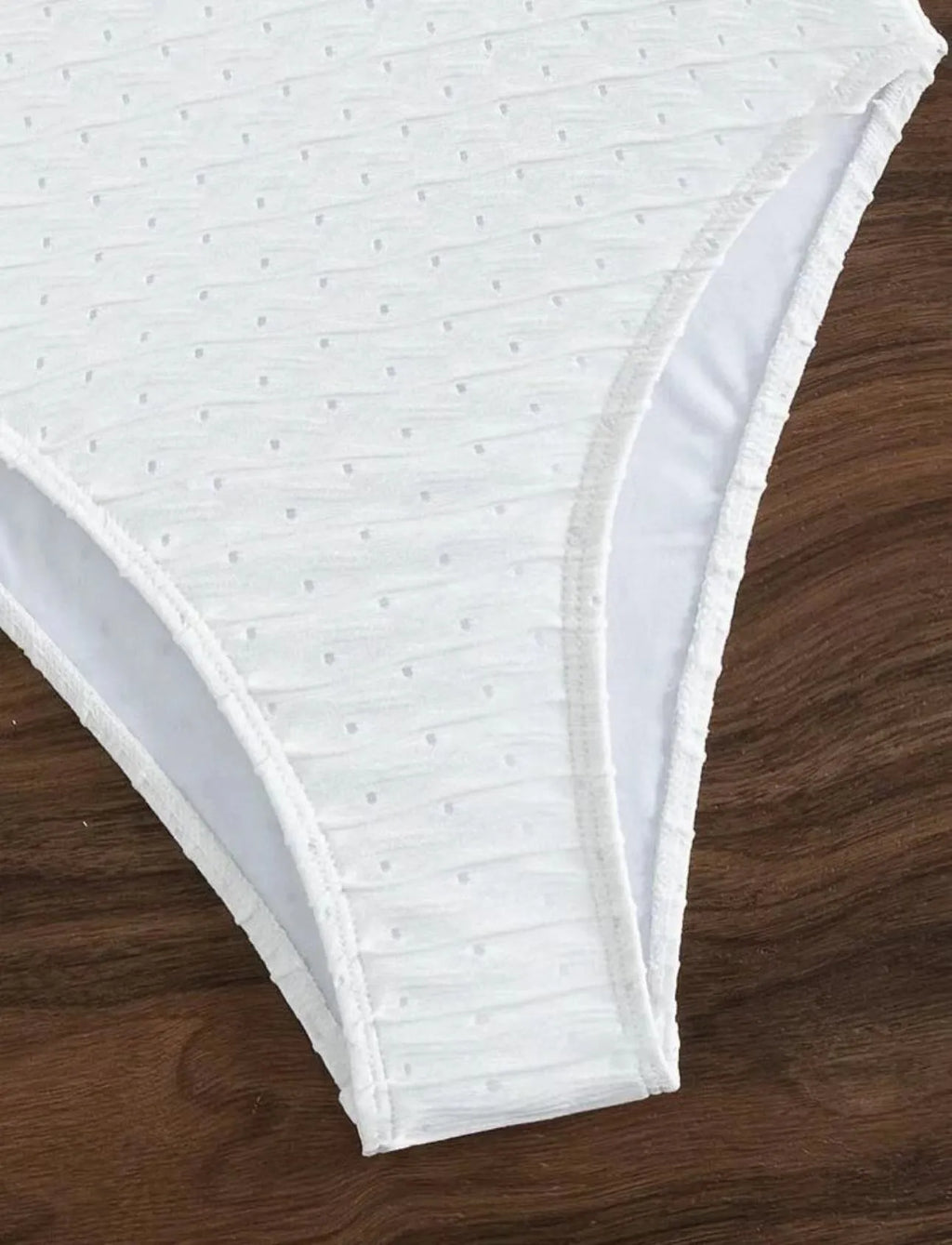 White women's one-piece swimsuit with a sling back and briefs-style cut.