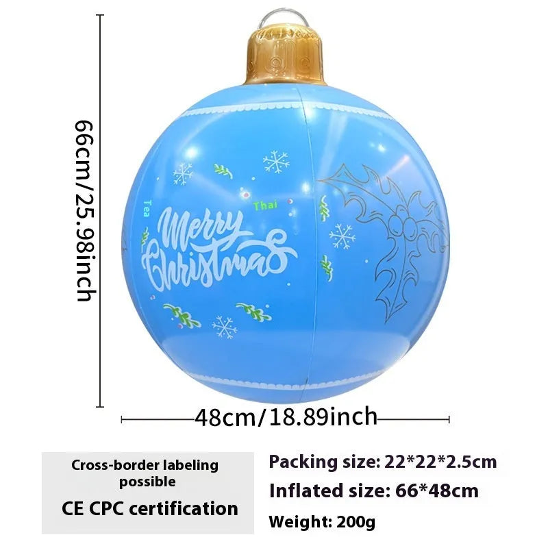 Large red inflatable Christmas ball with flashing lights displayed on a winter garden lawn.