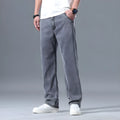 Man wearing light blue loose straight-leg lyocell jeans with a zipper fly.