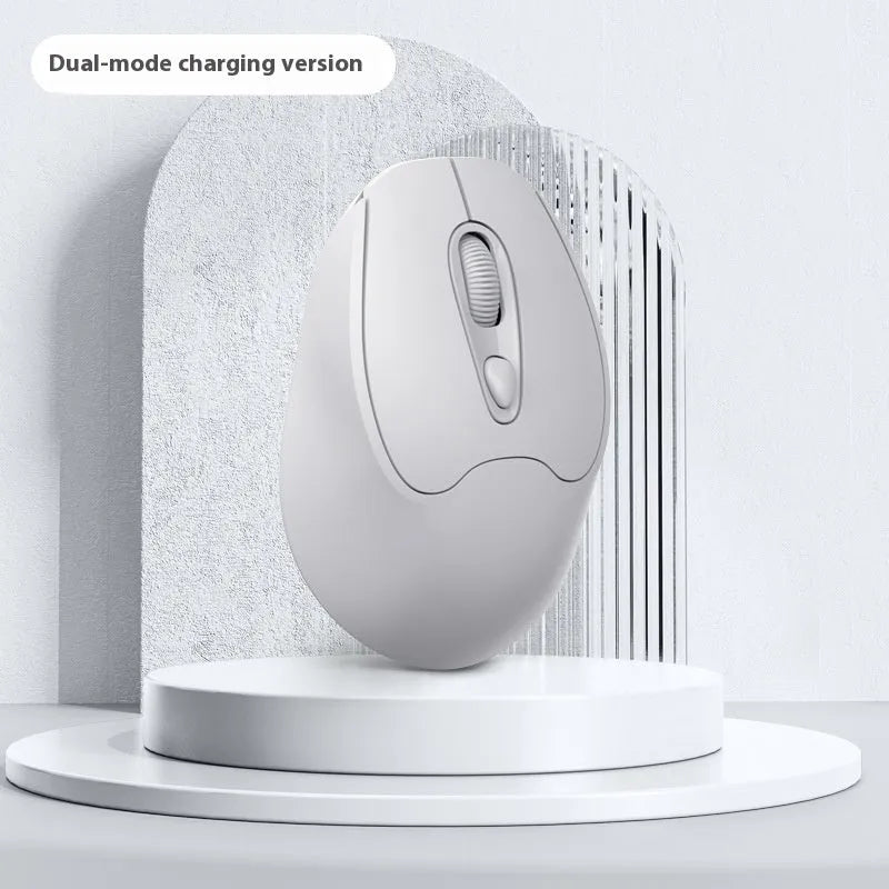 Bluetooth wireless mouse in choice of girl pink, milk tea pink, grey or green colours on a desk next to a laptop.
