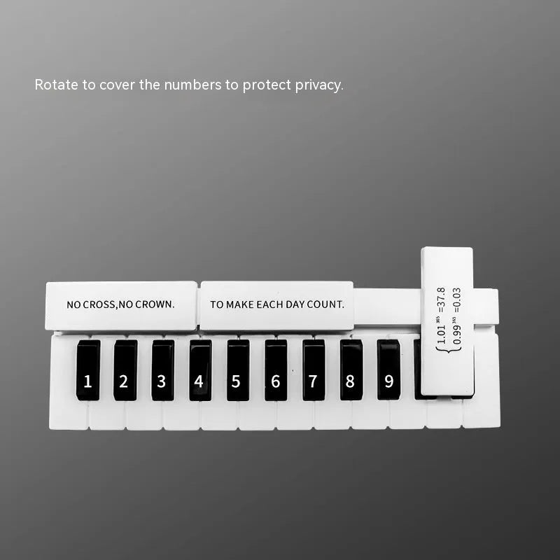 Black and white plastic piano temporary parking sign for car dashboard.