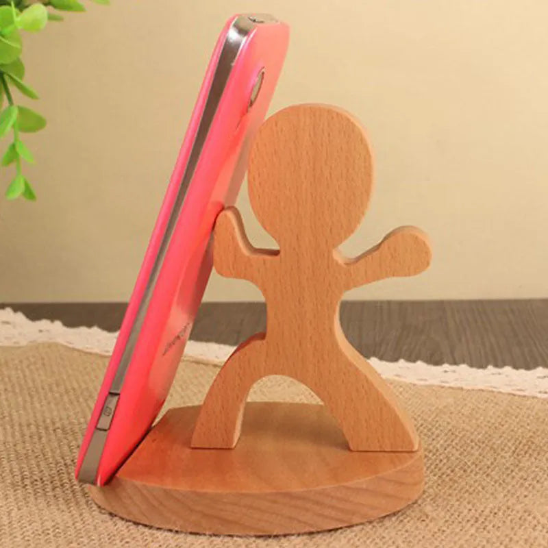 Beech wood and resin lazy bracket mobile phone holder in an animal design style on a desk.