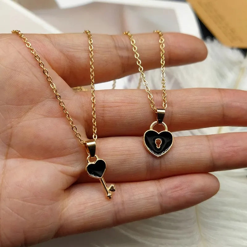 Small alloy lock and key pendant necklace set in black with 40cm chain on white background