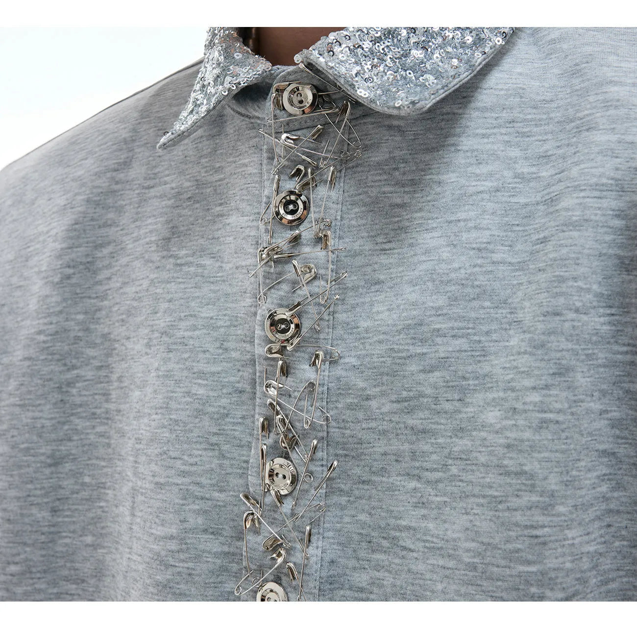 Loose fit black sequined shirt with square neckline and short sleeves on a model