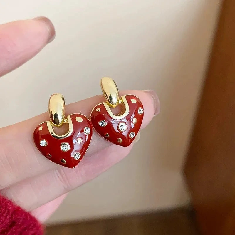 Pair of red heart-shaped ear studs in zinc alloy with electroplated finish