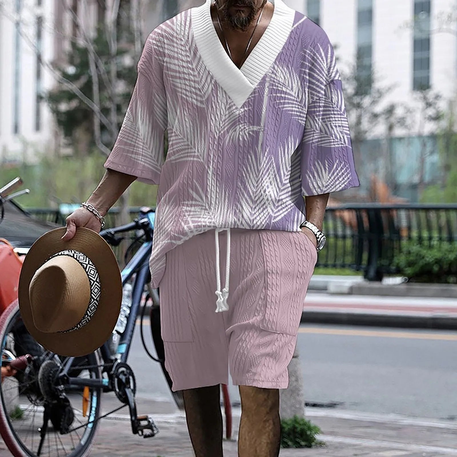 Man wearing a printed drop-shoulder knitted short-sleeve jacket with matching shorts in a casual setting.