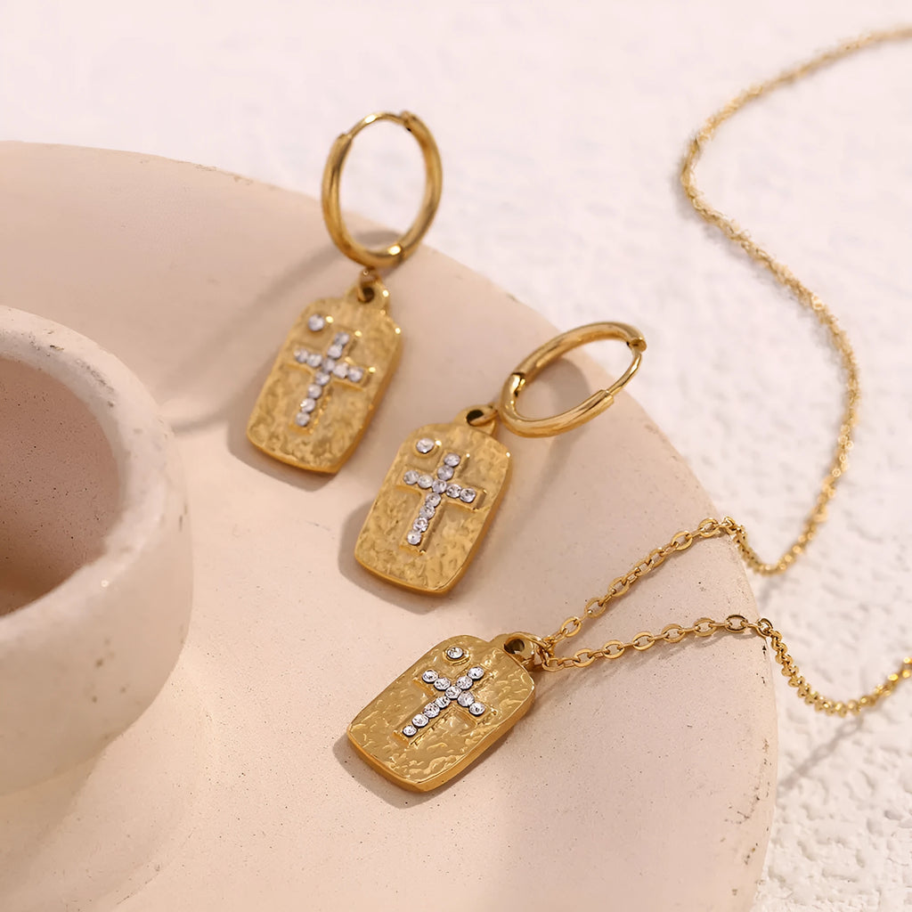 Gold micro inlay rhinestone cross hammer necklace on woman with quadrilateral geometric pendant on stainless steel chain