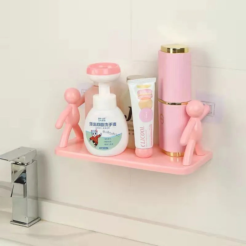 White plastic wall-mounted storage shelf in little man doll design on a bathroom wall