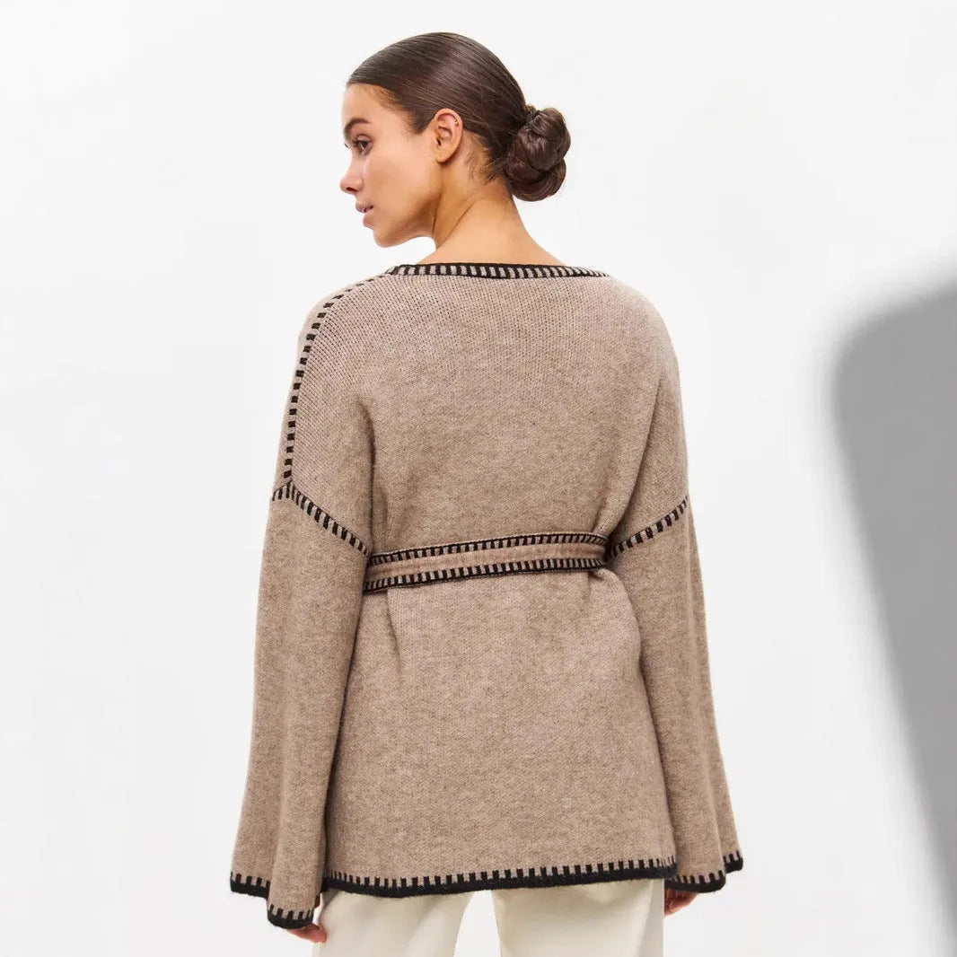 Loose black lace-up knitted cardigan sweater coat with long sleeves.