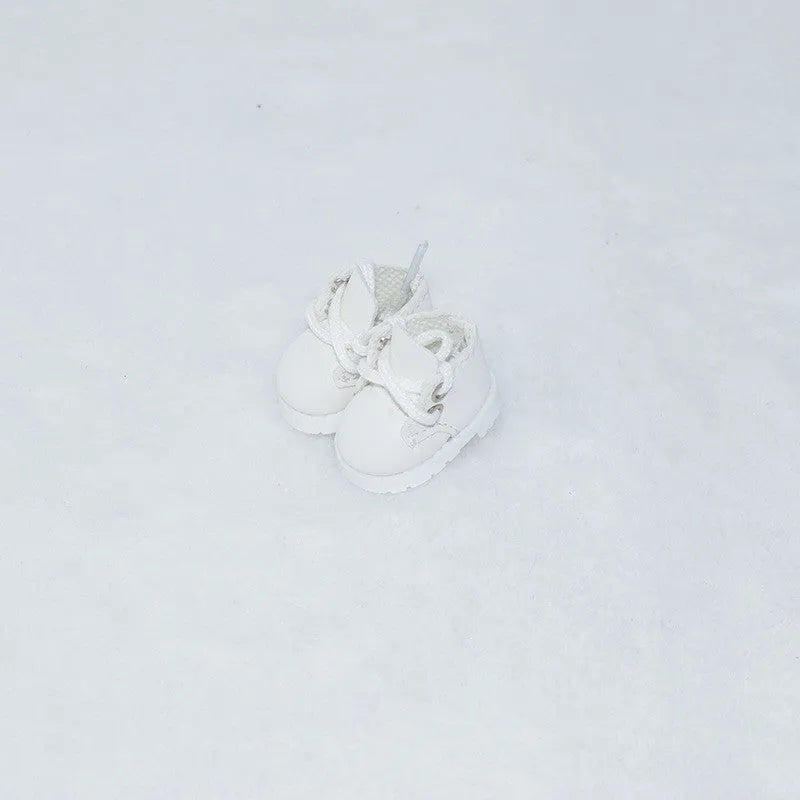 A pair of 17cm scale PU doll shoes in a selected colour and style, such as black leather shoes or brown boots.