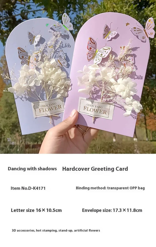 Handmade 3D butterfly-shaped greeting card with artificial flowers in a box, alongside its matching envelope.