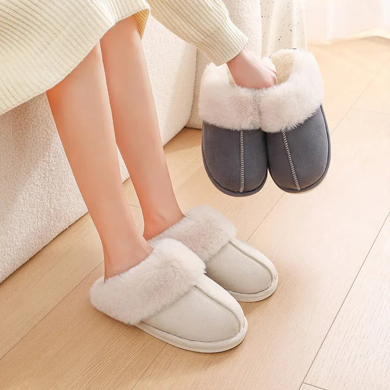 Brown plush indoor slippers with round toe, flat heel, and stitched detail on a PVC sole.