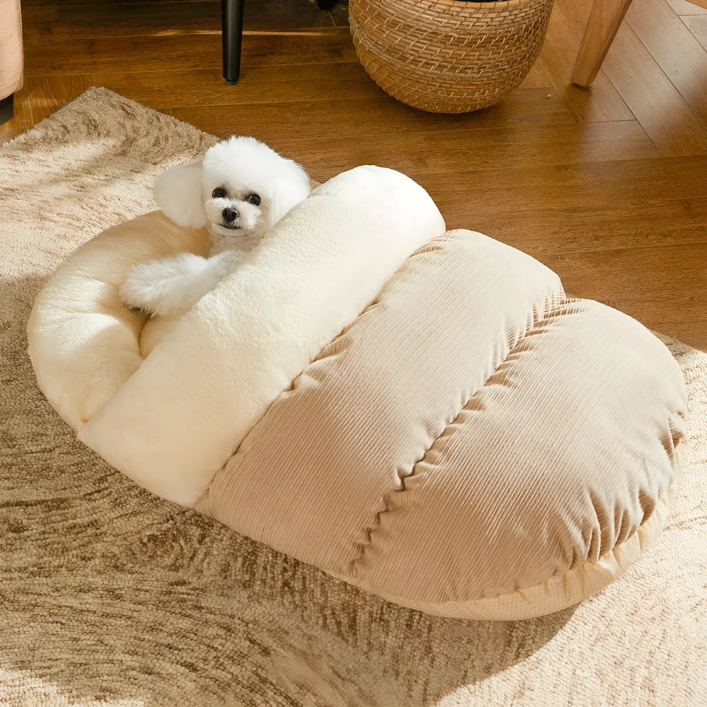 Grey slipper-shaped cat cave bed with plush lining on a wooden floor.