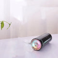 Portable black USB humidifier with colourful lights on car cup holder
